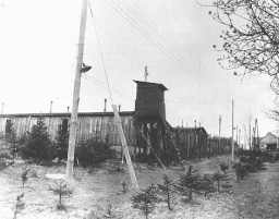 View of a watchtower and prisoner barracks at the Ohrdruf subcamp of the Buchenwald concentration camp, soon after US forces liberated ... [LCID: 85351]
