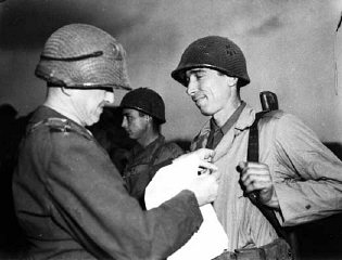 Sergeant Alexander Drabik, the first American soldier to cross the bridge at Remagen, receiving the Distinguished Service Cross for ...