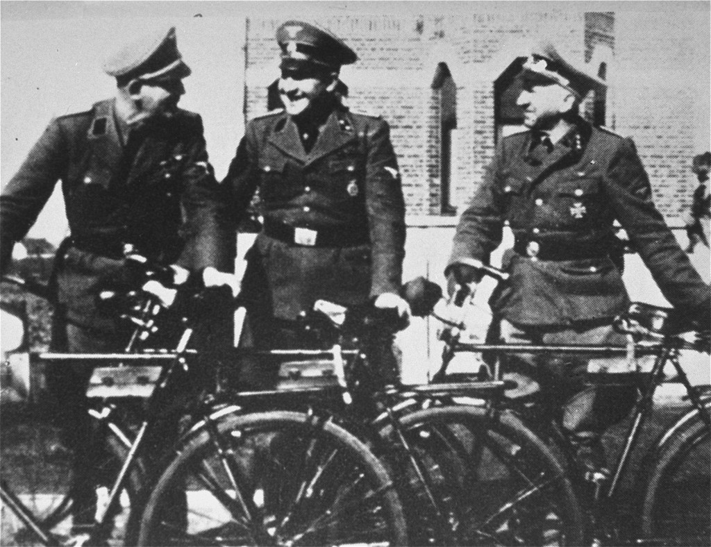 Three SS officers at the Breendonk internment camp: from left, First Lieutenant Hans Kantschuster, Master Sergeant Walter Mueller, ... [LCID: 24158]