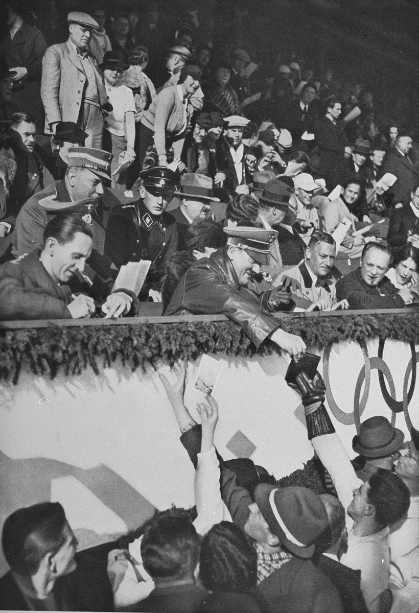 Adolf Hitler and Joseph Goebbels sign autographs for members of the Canadian figure skating team at the Winter Olympic Games. [LCID: 02322]