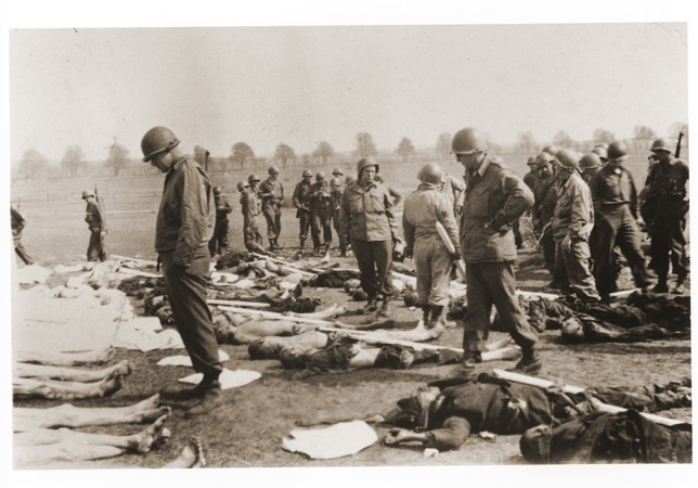 American soldiers view the bodies of prisoners laid out in rows in an open field at Ohrdruf, a subcamp of Buchenwald in Germany. The 4th Armored and 89th Infantry Divisions liberated Ohrdruf on April 4, 1945. It was the first concentration camp American forces encountered and, as such, it revealed the extent of German atrocities in the camps. Generals Dwight D. Eisenhower, Omar Bradley, and George S. Patton visited Ohrdruf on April 12, 1945 to witness to the conditions there.