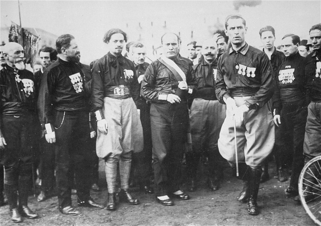 Italian Fascist leader Benito Mussolini (center) with aides and supporters. They are wearing the attire which gave them the name of blackshirts. Italy, 1920s.