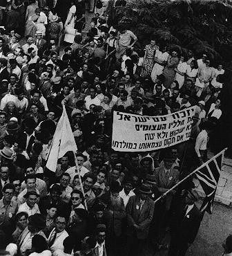  Jewish demonstration in Jerusalem on V-E Day. The words on the banner translate as: "The people of Israel remember our huge losses. [LCID: 11212]