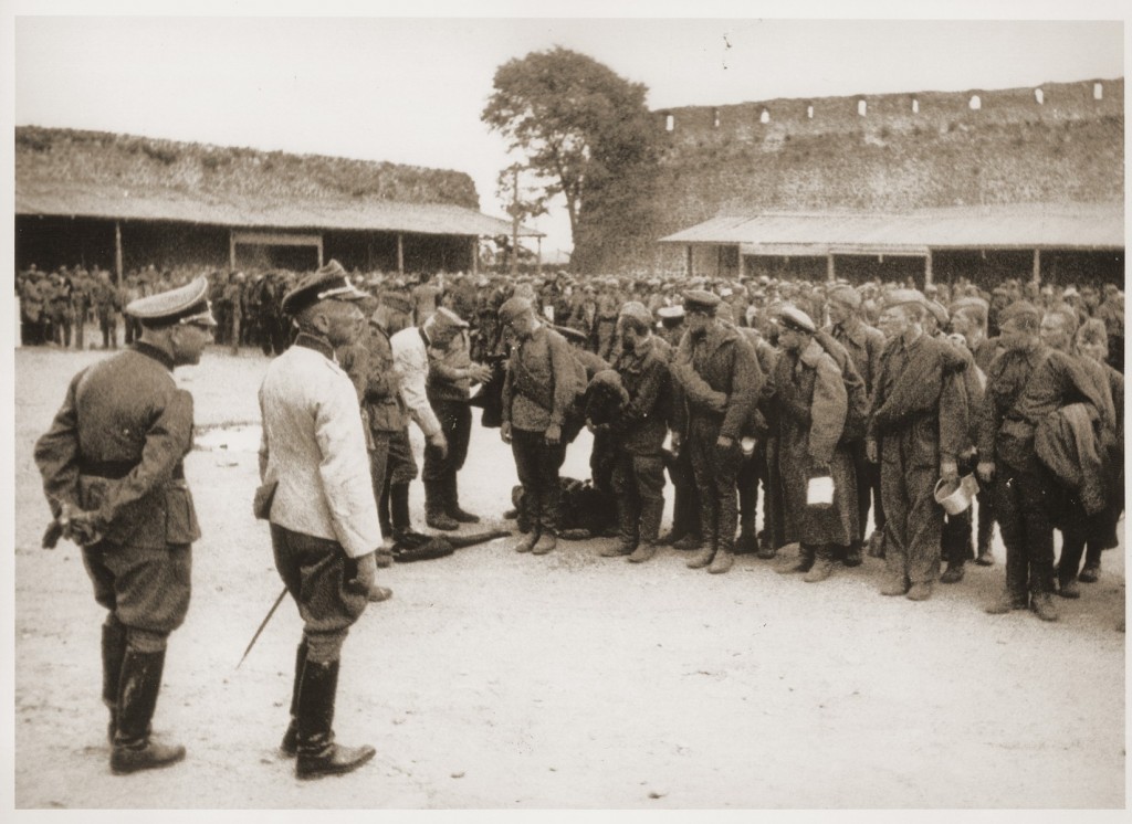 Soviet prisoners of war interrogated by German soldiers upon arrival at a prison camp. [LCID: 81525]