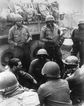 Members of the 12th Armored Division, which included African American platoons, await their orders.