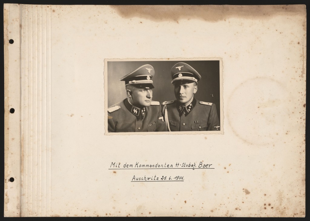 Front cover of a photo album. In the center is a photograph of two uniformed Nazi soldiers. German text is handwrtten underneath the photograph.