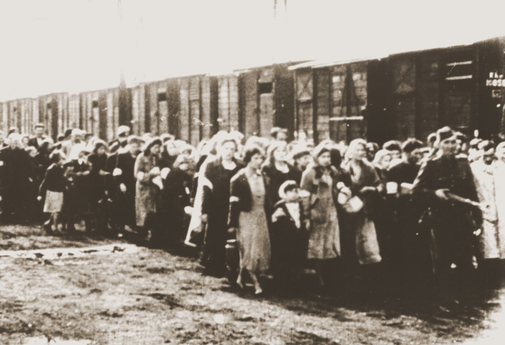 Jews being deported from the Warsaw ghetto march to the freight trains.