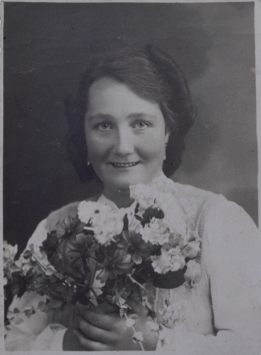 Formal portrait of Frieda Greinegger holding a bouquet of flowers. [LCID: n02820]