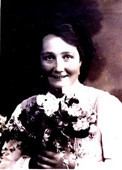 Formal portrait of Frieda Greinegger holding a bouquet of flowers. [LCID: n02820]