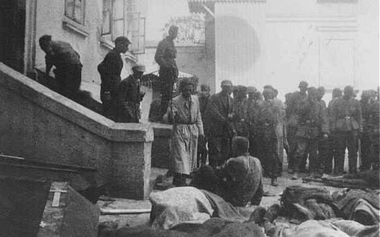  German soldiers and Ukrainian civilians look at Jews wounded or killed during a pogrom in Tarnopol. [LCID: 23094a]