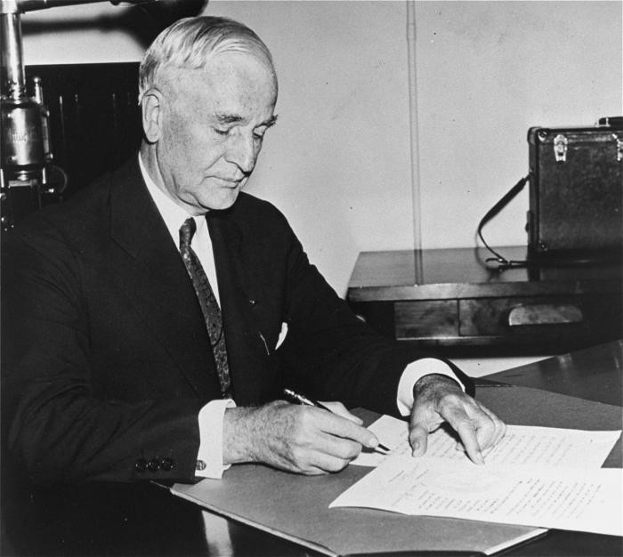 Portrait of Secretary of State Cordell Hull signing the president's Neutrality Proclamation.