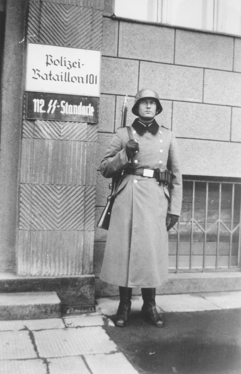 Bernhardt Colberg, a member of Reserve Police Battalion 101 poses in front of its headquarters in the vicinity of Lodz in German-occupied Poland. The police battalions were units of the German Order Police and were deployed to German-occupied areas of Europe during World War II. Photo dated 1940–1941.