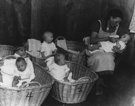 German propaganda photograph of a kindergarten for German infants promotes the nurturing role of women on the home front.