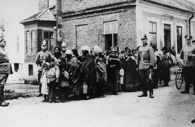 German police guard a group of Roma (Gypsies) who have been rounded up for deportation to Poland. Germany, 1940–45.