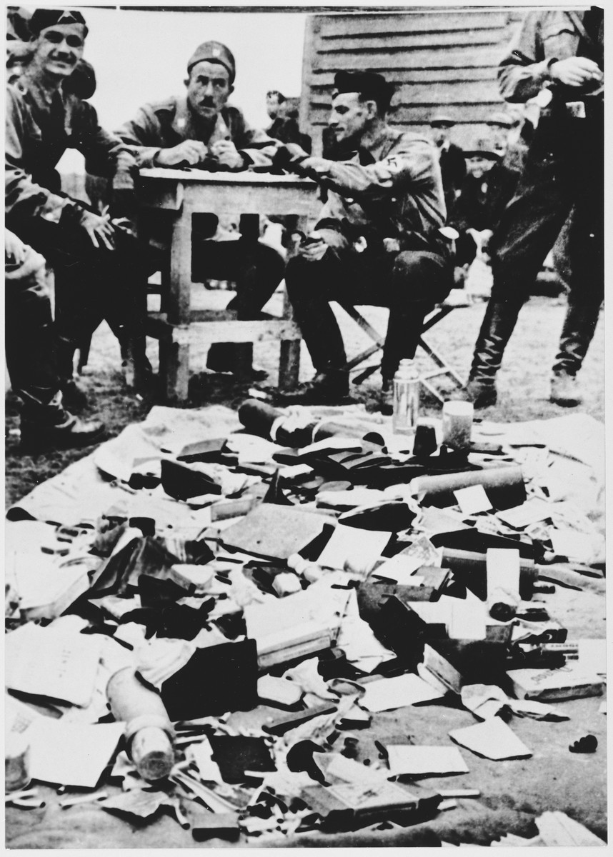 Ustasa (Croatian fascist) guards alongside belongings of prisoners at the Jasenovac concentration camp. [LCID: 68290b]