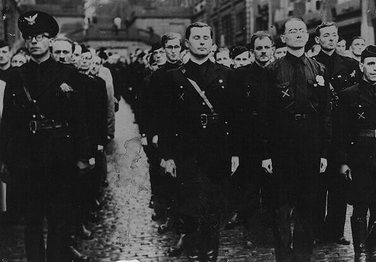  Leon Degrelle, leader of the Belgian Nazi party, stands in formation with fighters from the Belgian Volunteers, who are on their ...