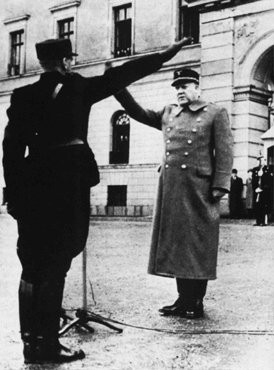Vidkun Quisling, leader of the collaborationist Norwegian government, returns a salute during a ceremony in Oslo. [LCID: tl207]