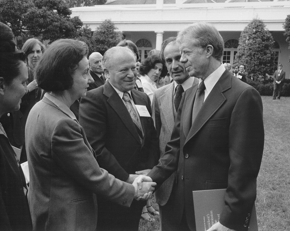 Vladka Meed shakes the hand of President Jimmy Carter at a White House Rose Garden ceremony marking the official presentation of the report of the US Holocaust Commission to the president by commission chairman Elie Wiesel (second from right, with Benjamin Meed, center).