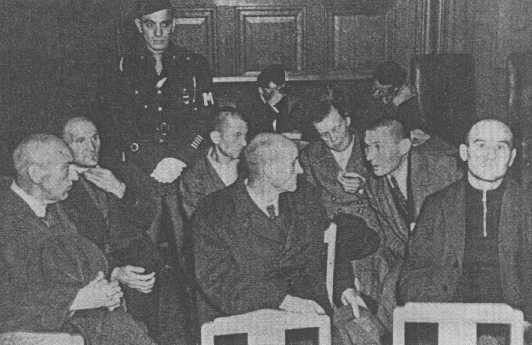 Staff from the Hadamar euthanasia center, including senior physician Adolf Wahlmann (front, left), during their trial. [LCID: 02502]