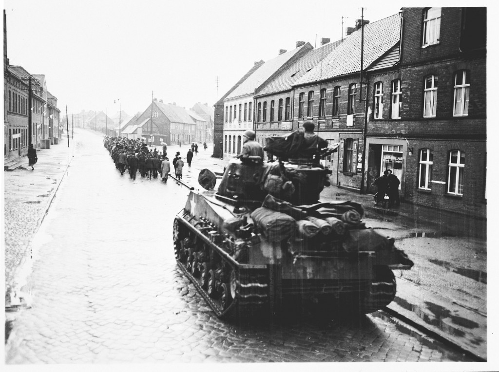 An American tank follows German civilians from Gardelegen who are marching to a barn just outside the town, where they will dig graves ... [LCID: 81374]
