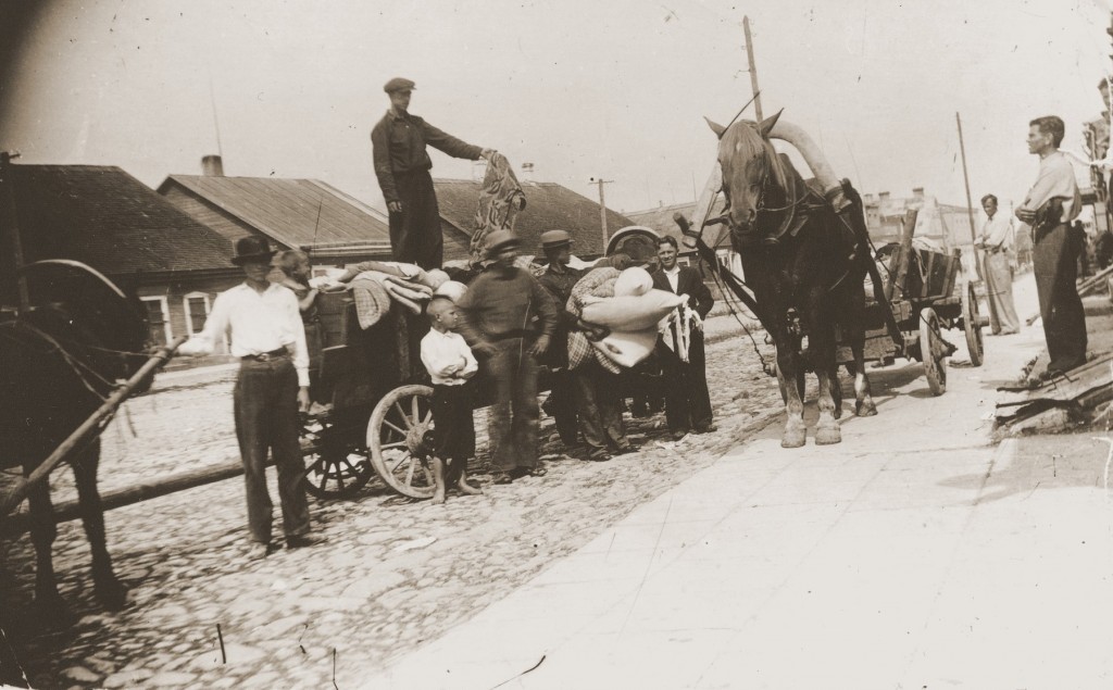 A Lithuanian auxiliary policeman auctions off property owned by persons killed in SS-managed shooting operations. [LCID: 25736]