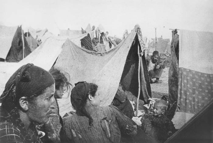 Armenian families next to makeshift tents in a refugee camp. Ottoman Empire, 1915-16.Photograph taken by Armin T. Wegner. Wegner served as a nurse with the German Sanitary Corps. In 1915 and 1916, Wegner traveled throughout the Ottoman Empire and documented atrocities carried out against the Armenians. [Courtesy of Sybil Stevens (daughter of Armin T. Wegner). Wegner Collection, Deutsches Literaturarchiv, Marbach & United States Holocaust Memorial Museum.]