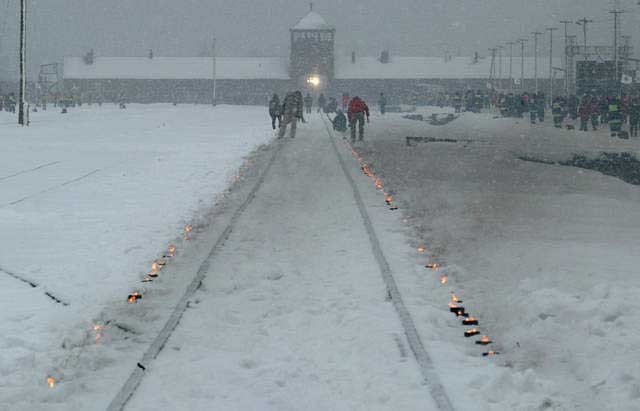Candles mark the railway tracks leading to the Auschwitz camp during the commemoration of the 60th anniversary of the liberation ... [LCID: lc501]