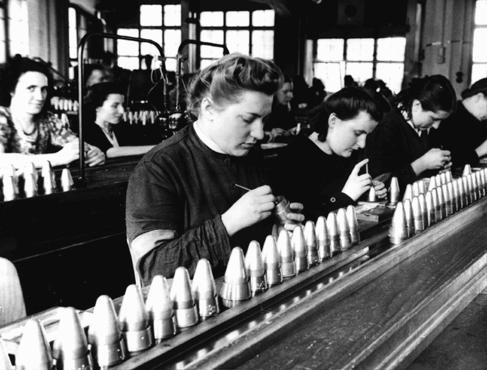 <p>Women at work in Germany's armaments industry. The women in front are forced laborers brought in from a nearby prison. Place uncertain, May 1943.</p>