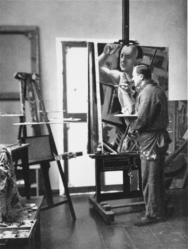 Georg Grosz, a Communist satirical artist and painter, seen here in his studio in Berlin. He fled Germany shortly before the Nazi rise to power in 1933 and was one of the first to be stripped of his German citizenship by the Nazis. Berlin, Germany, 1929.