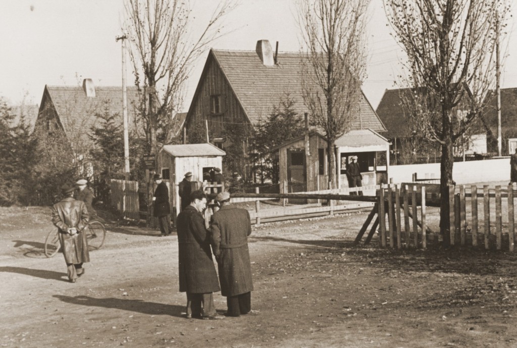 Jewish displaced persons (DPs) converse on the streets of the Neu Freimann DP camp, circa 1946–1948.The photographer, Jack Sutin, lived at the camp with his family and worked as a camp administrator and photojournalist.