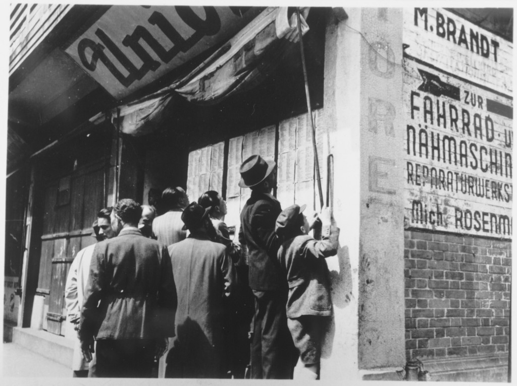 Jewish refugees in Shanghai look for names of relatives and friends who may have survived the war. [LCID: 66385]