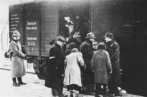 <p>A member of the German SS supervises the boarding of Jews onto trains during a deportation action in the <a href="/narrative/3055">Krakow</a> ghetto. Krakow, Poland, 1941–1942.</p>