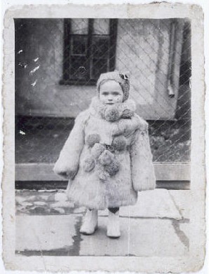 Portrait of three-year-old Estera Horn wrapped in a fur coat.