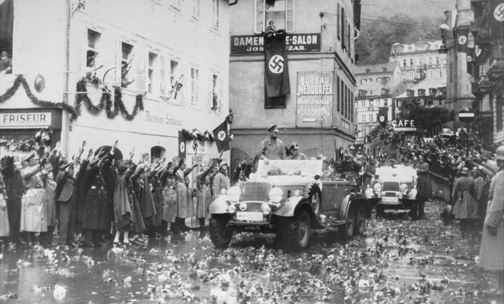 Soldiers and civilians greet Adolf Hitler during his visit following the German annexation of the Sudetenland. [LCID: 70928]