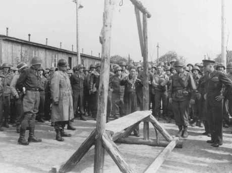 <p>A Dutch survivor shows Generals Eisenhower, Patton, and Bradley the gallows at the Ohrdruf camp. Ohrdruf, Germany, April 1945.</p>