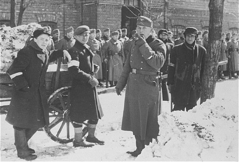  German soldiers force Jews to clear snow. Near Czestochowa, Poland, date uncertain. [LCID: 50386]
