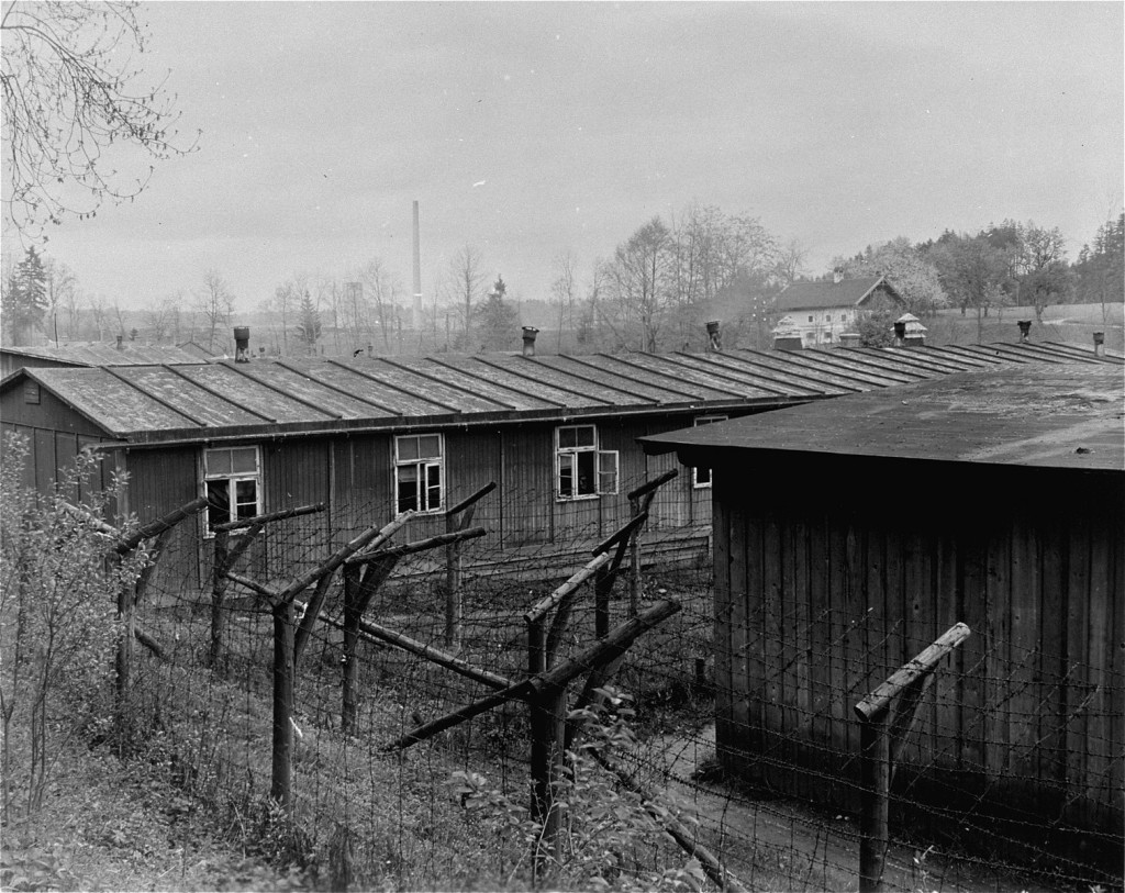 The barbed-wire fences and prisoner barracks after liberation at Ebensee, a subcamp of the Mauthausen concentration camp.