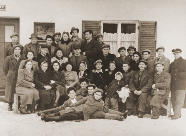 Group portrait of former Bielski partisans from Nowogrodek taken in the Foehrenwald displaced persons camp. [LCID: 99534]