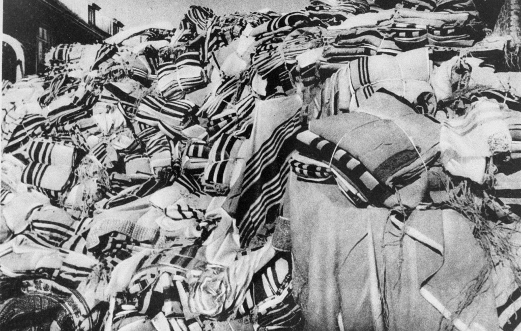 Piles of prayer shawls that belonged to Jewish victims, found after the liberation of the Auschwitz camp. [LCID: 85743]