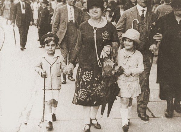 <p>Simone Weil (right), her mother Jeanne, and her brother Roger stroll along a street in Strasbourg. France, 1926.</p>