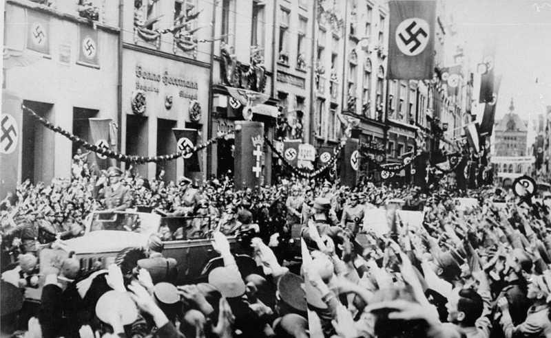 Saluting Germans greet Adolf Hitler (standing at front of car) as he enters Danzig. The Danzig District was incorporated into Greater Germany following the invasion of Poland. Danzig, September 19, 1939.