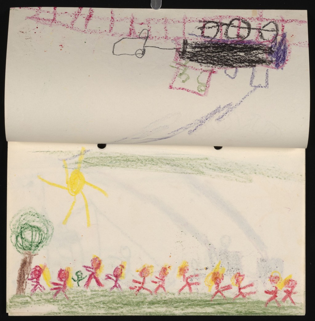 The inside of a child’s sketch book. The top page is flipped upside down with a rudimentary crayon drawing of a train, complete with billowing smoke from the engine. The bottom page is a crayon drawing of a large group of stick figures under a bright sun. There is a short tree on the left side.