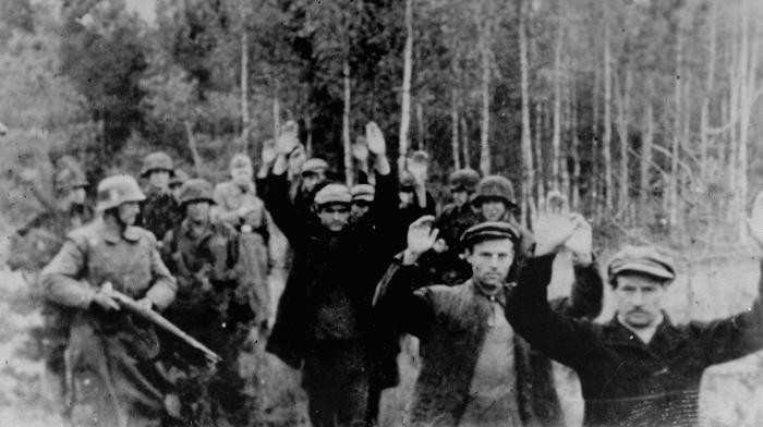 SS troops lead a group of Poles into the forest near Witaniow for execution. Witaniow, Poland, October–November 1939. 
