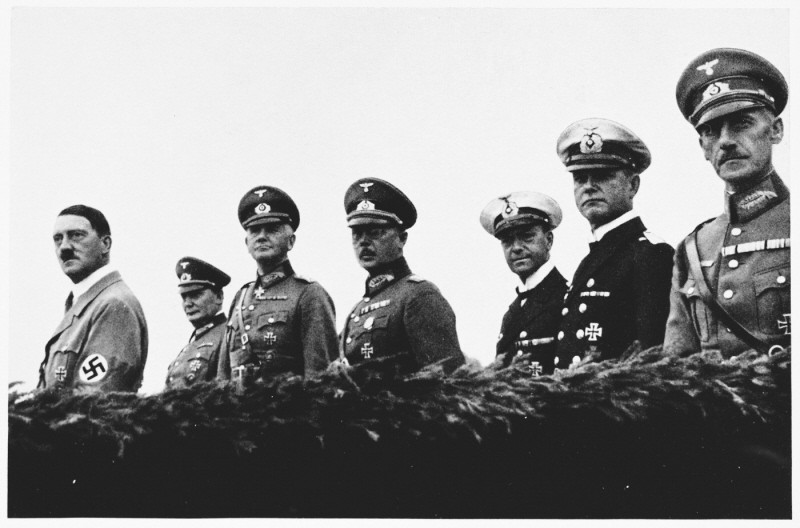 Adolf Hitler stands with his military high command at an inspection of German armed forces. From left to right: Hitler, Hermann Göring, Werner von Blomberg (armed forces), Erich von Fritsch (army) and Erich Raeder (navy). Germany, 1935.