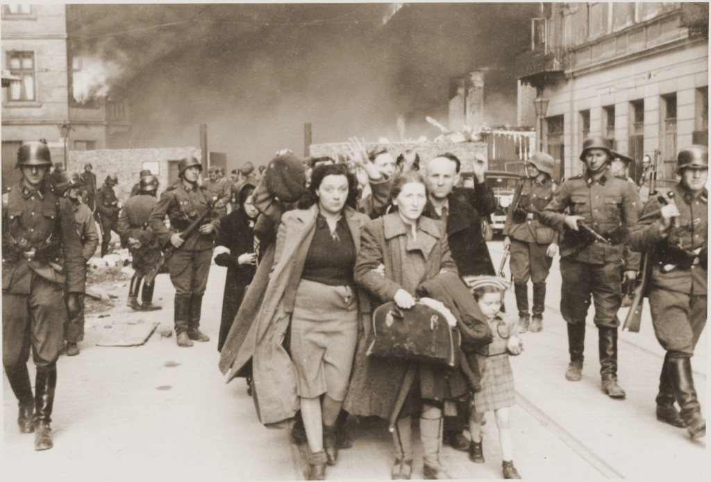 German soldiers lead Jews captured during the Warsaw ghetto uprising to the assembly point for deportation.