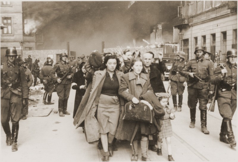 German soldiers lead Jews captured during the Warsaw ghetto uprising to the assembly point for deportation. [LCID: 5472a]