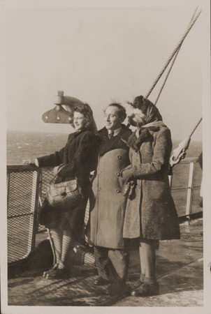 Rozalia (Krysia Laks) Lerman, Miles Lerman, and Regina Laks stand on the deck of the Marine Perch while en route to the United States. [LCID: 29724]