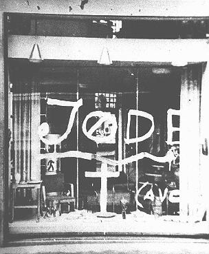 Antisemitic graffiti on the window of a Jewish-owned store. [LCID: 88999]