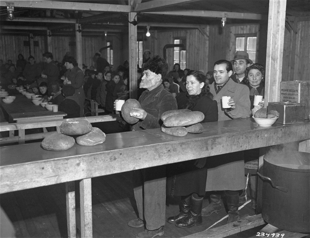 Jewish displaced persons receive food at the United Nations Relief and Rehabilitation Administration (UNRRA) Bindermichl displaced ...