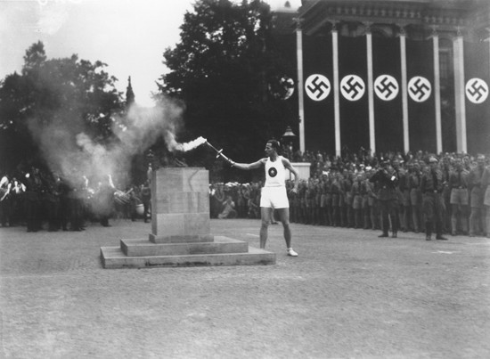 The last of the 3,000 runners who carried the Olympic torch from Greece lights the Olympic Flame in Berlin to start the 11th Summer ... [LCID: 21680]